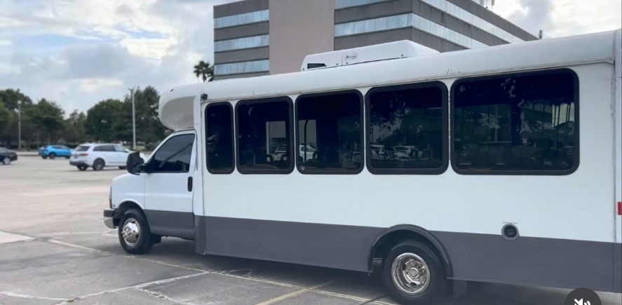 Frenzy Black Trucking 20-passenger group shuttle bus parked in New Orleans